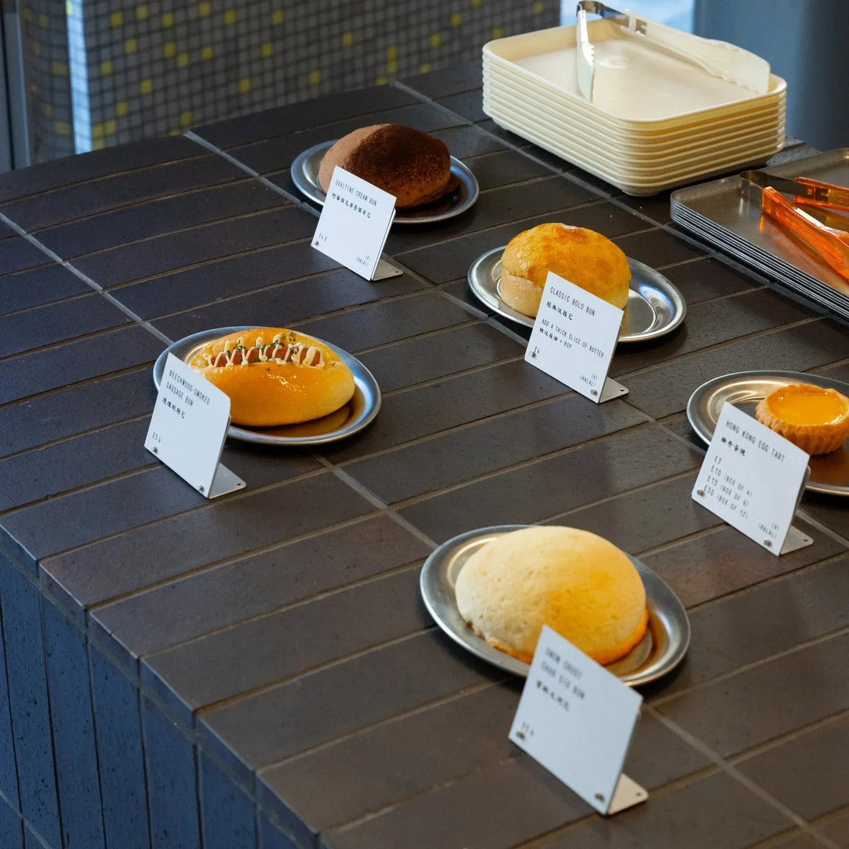 Bakes, trays and orange tongs arranged on the HOKO counter